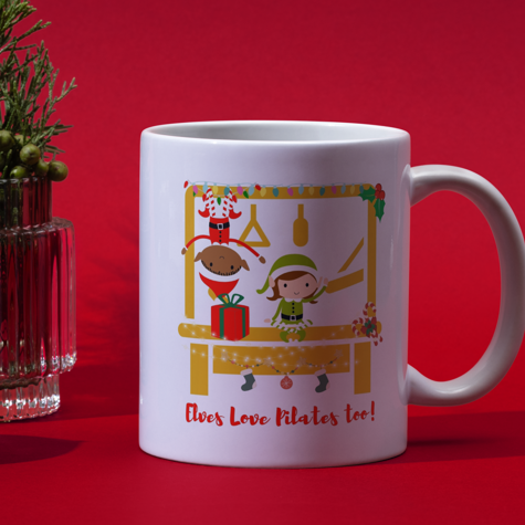 2 elves working out on the pilates trapeze table getting ready to deliver presents