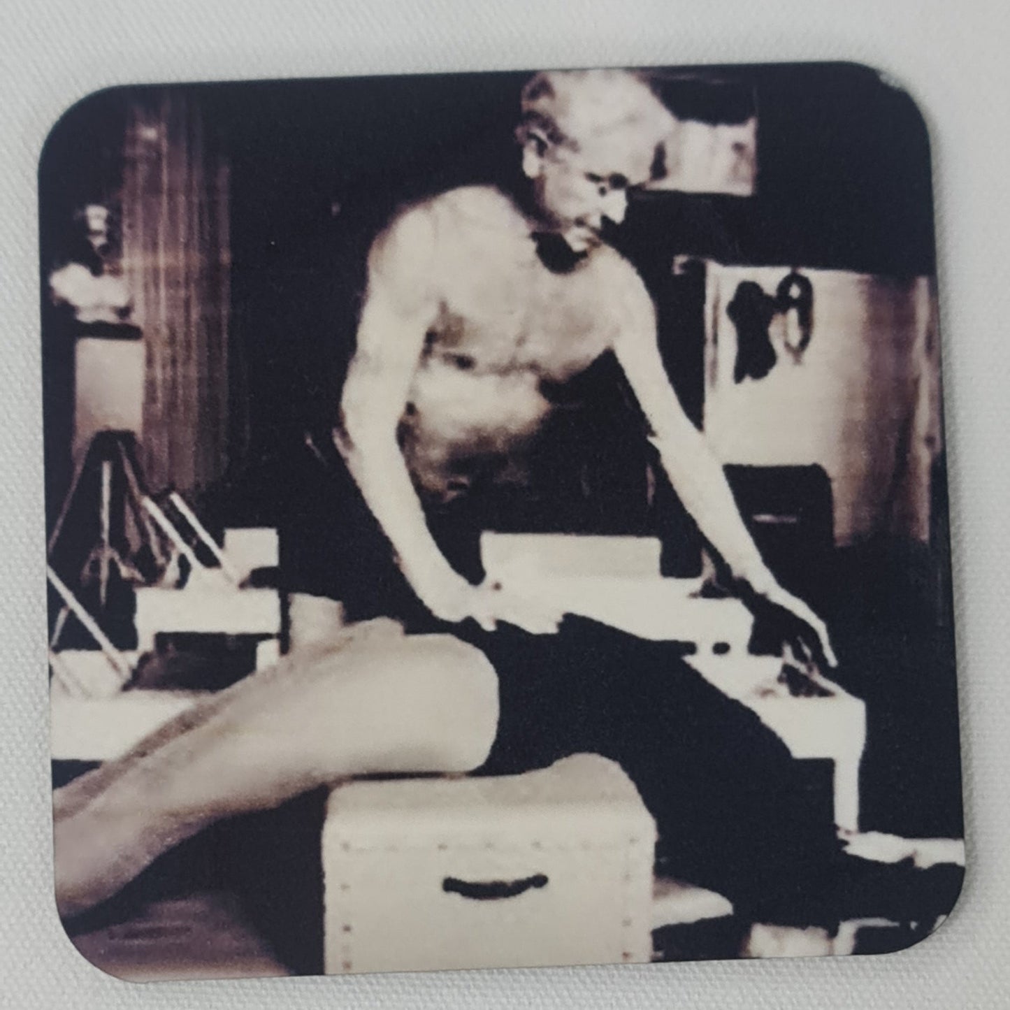 joseph pilates showing correction for climb a tree exercise on the reformer. classic black and white