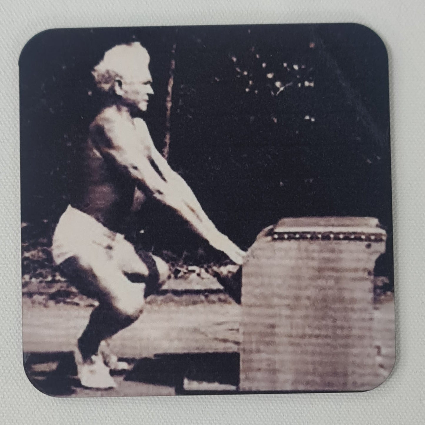 classic picture of joseph pilates performing arms series on a wunda chair in squat / frog position