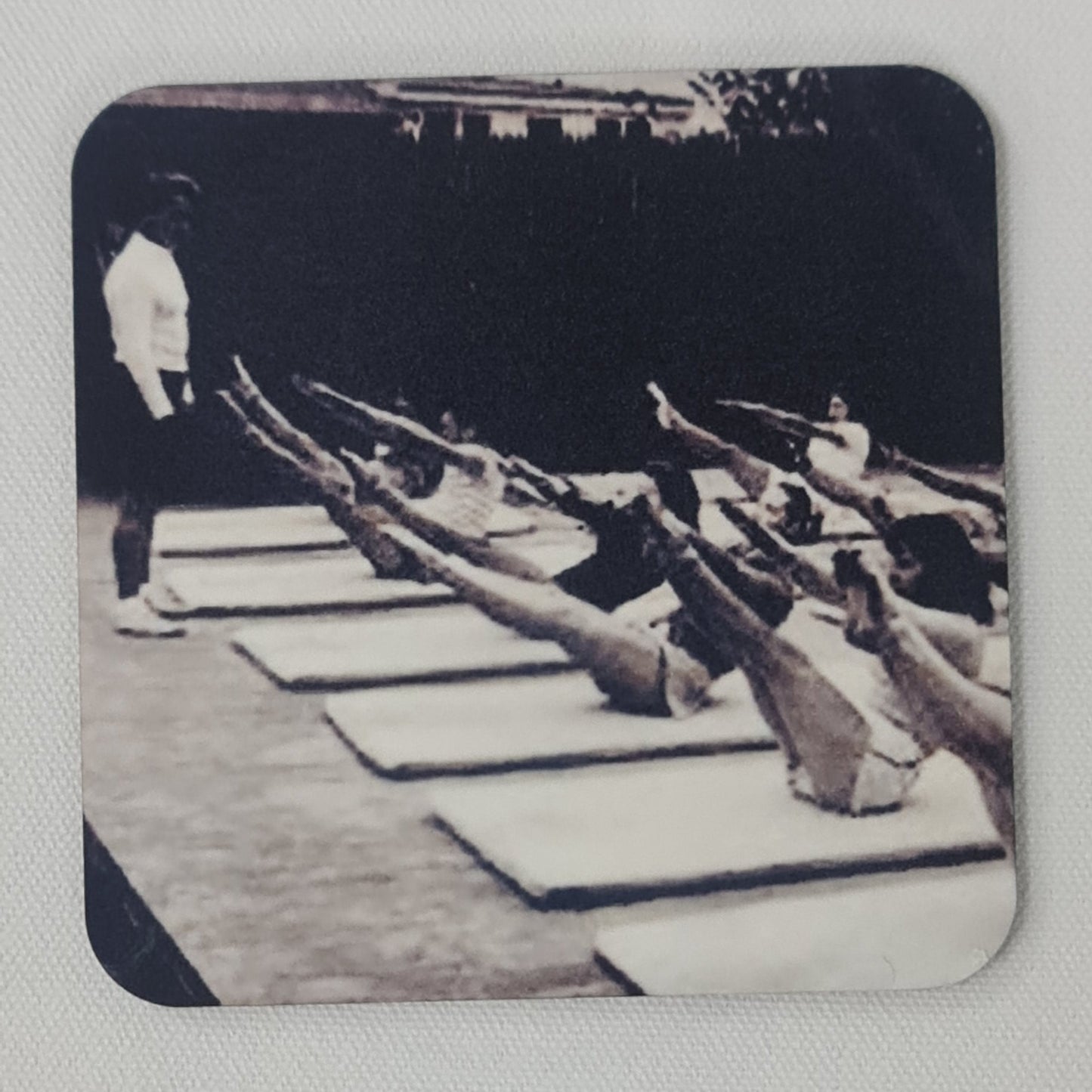 joseph pilates taking a pilates class performing the teaser exercise