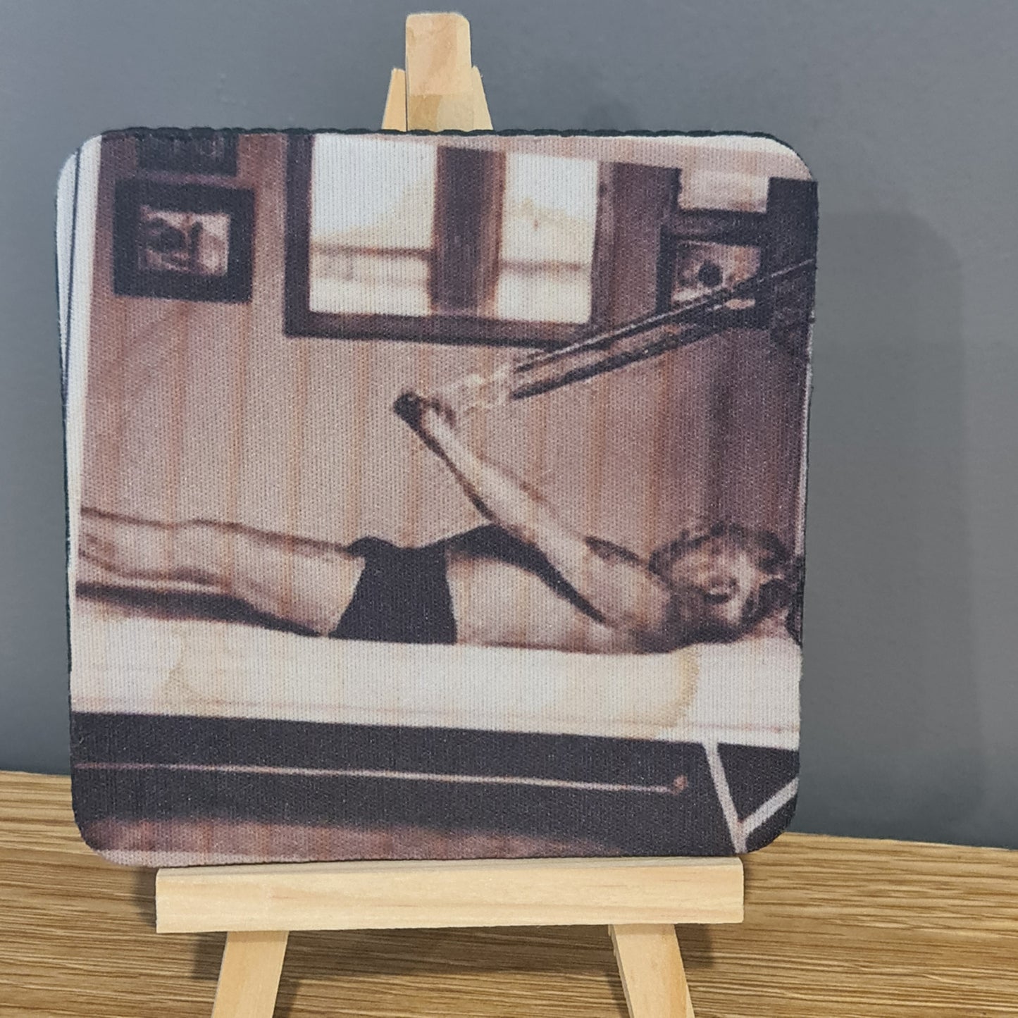 joseph pilates doing teh hundred exercise on th etrapeze table -  photo on square neoprene coaster